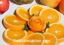 How to serve orange fancy way with flower. Photo.
