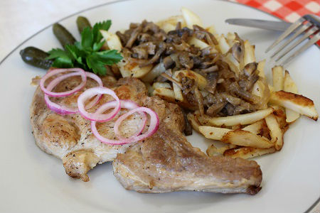 Photo Russian Style Pork Chops garnished with red onion