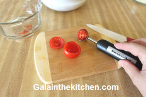 Photo How to use melon baller to hallow tomatoes