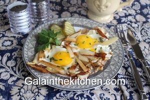 Fried potatoes with eggs on a pan